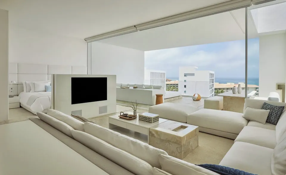 Ocean-view suite living room with bedroom and terrace visible at Viceroy Los Cabos.