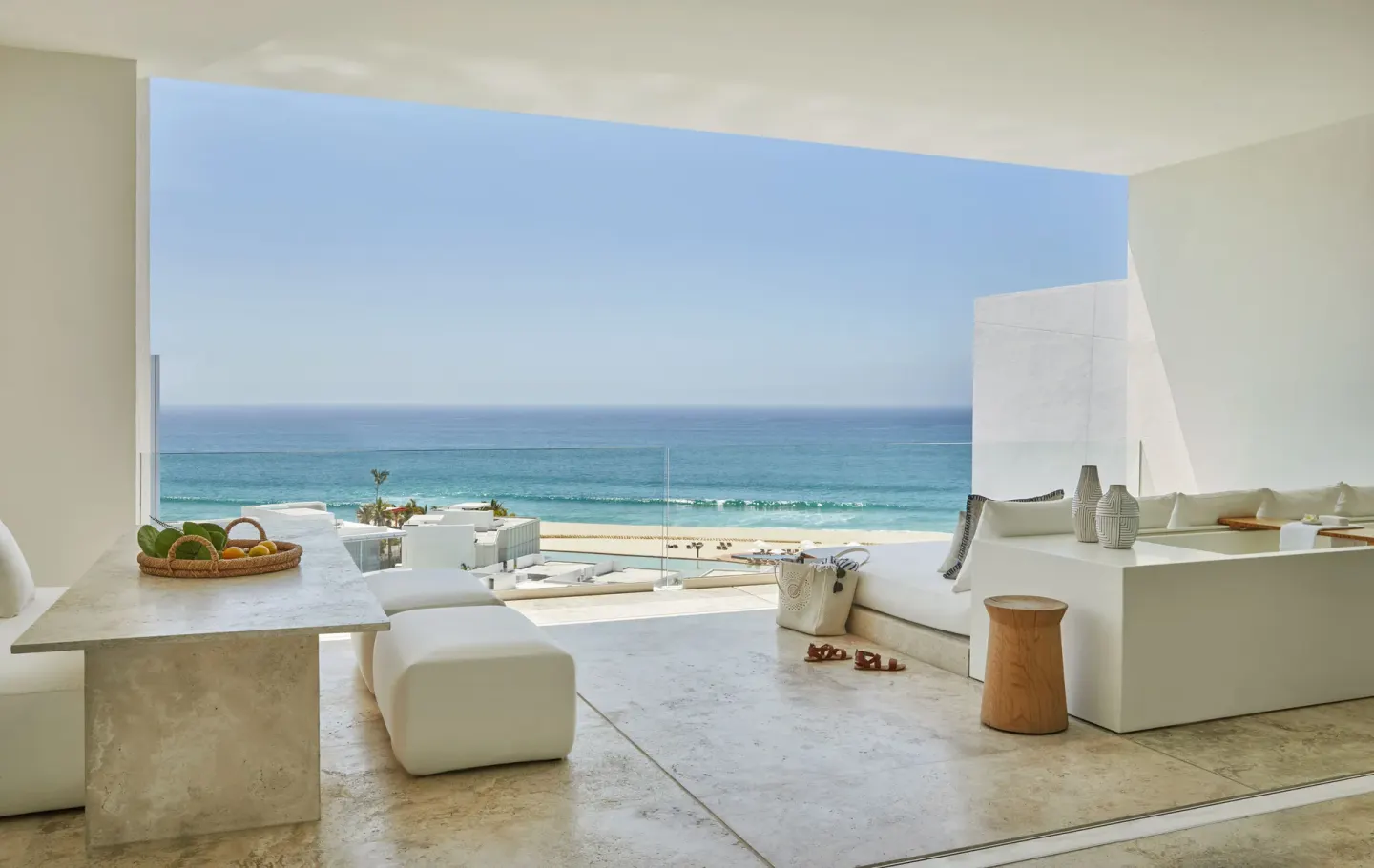 Ocean-view suite terrace with white seating and dining table at Viceroy Los Cabos.
