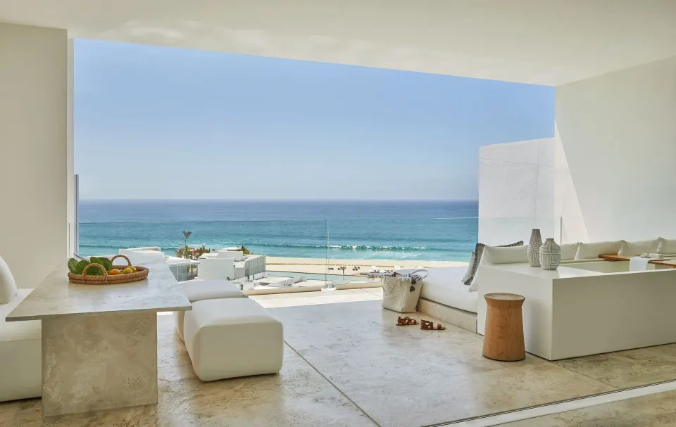 Ocean-view suite terrace with white seating and dining table at Viceroy Los Cabos.
