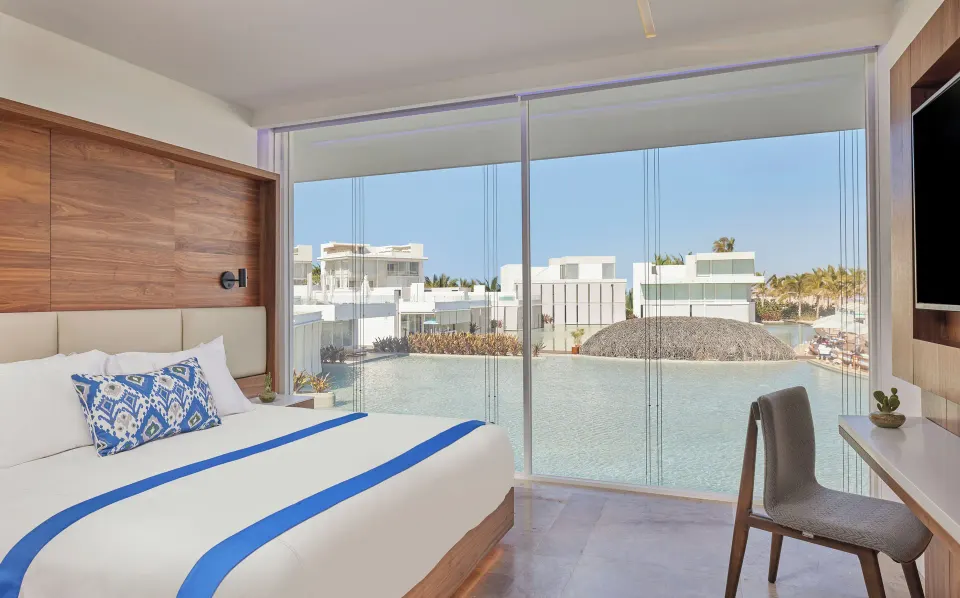 Suite bedroom with king bed and lagoon view at Viceroy Los Cabos.