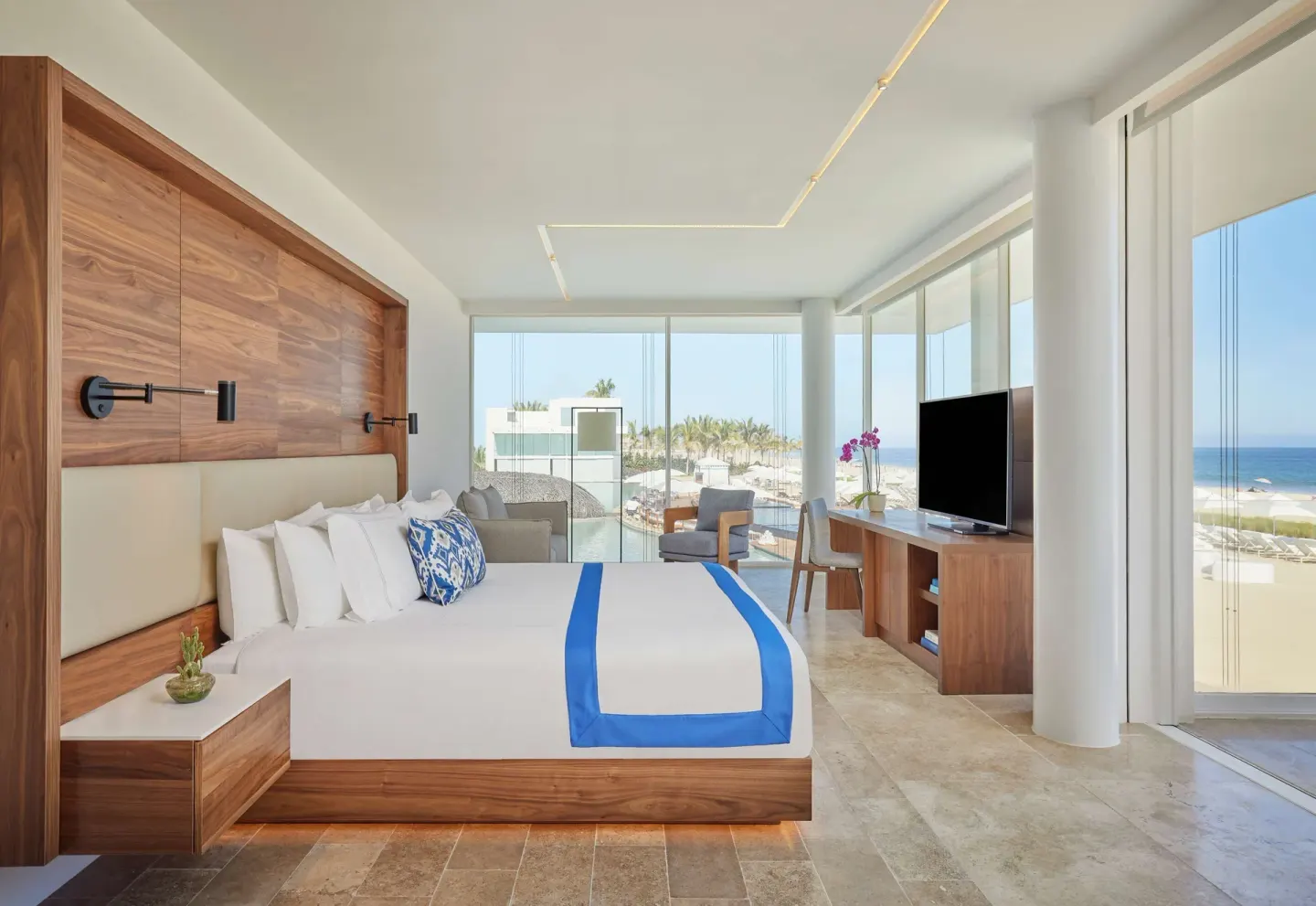 Oceanfront suite bedroom with king bed and sea view at Viceroy Los Cabos.