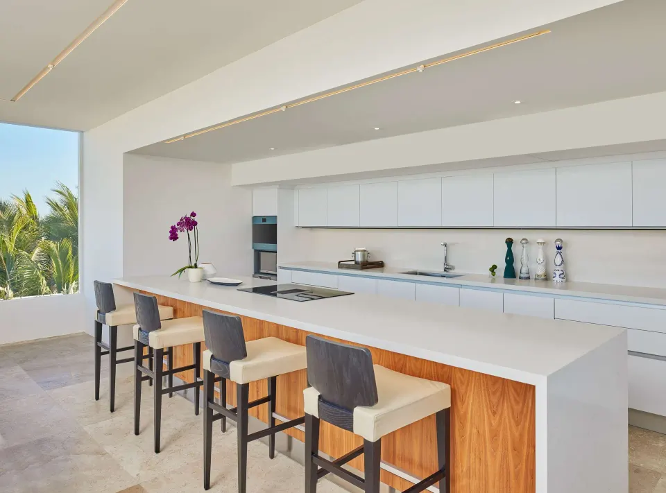 Oceanfront suite kitchen with island seating at Viceroy Los Cabos.