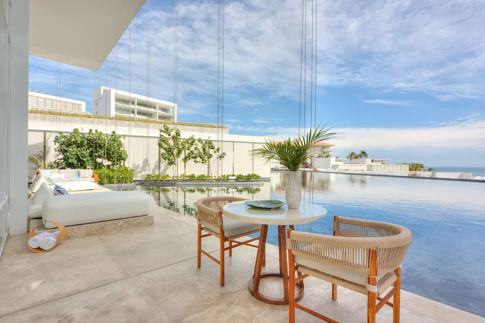 Ocean-view villa terrace with pool, daybed, and dining table at Viceroy Los Cabos.