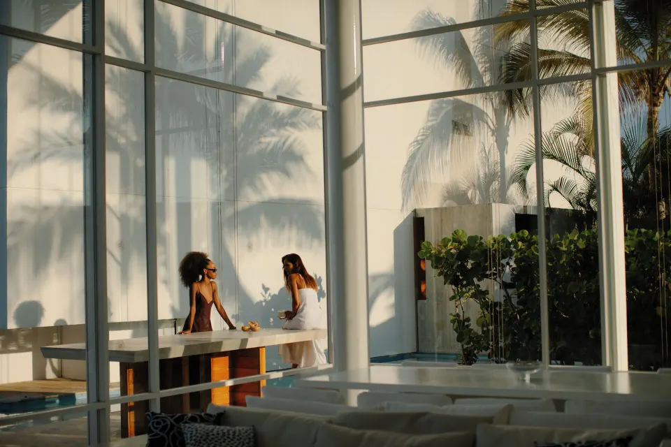 Villa dining table beside tall glass walls at Viceroy Los Cabos.