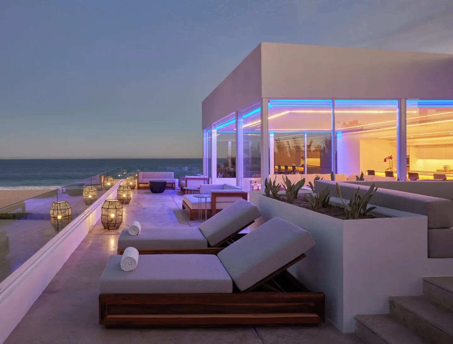 Oceanfront villa terrace with loungers and lanterns at Viceroy Los Cabos.