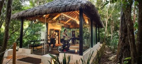 Glass-walled fitness pavilion in the jungle at Viceroy Riviera Maya.
