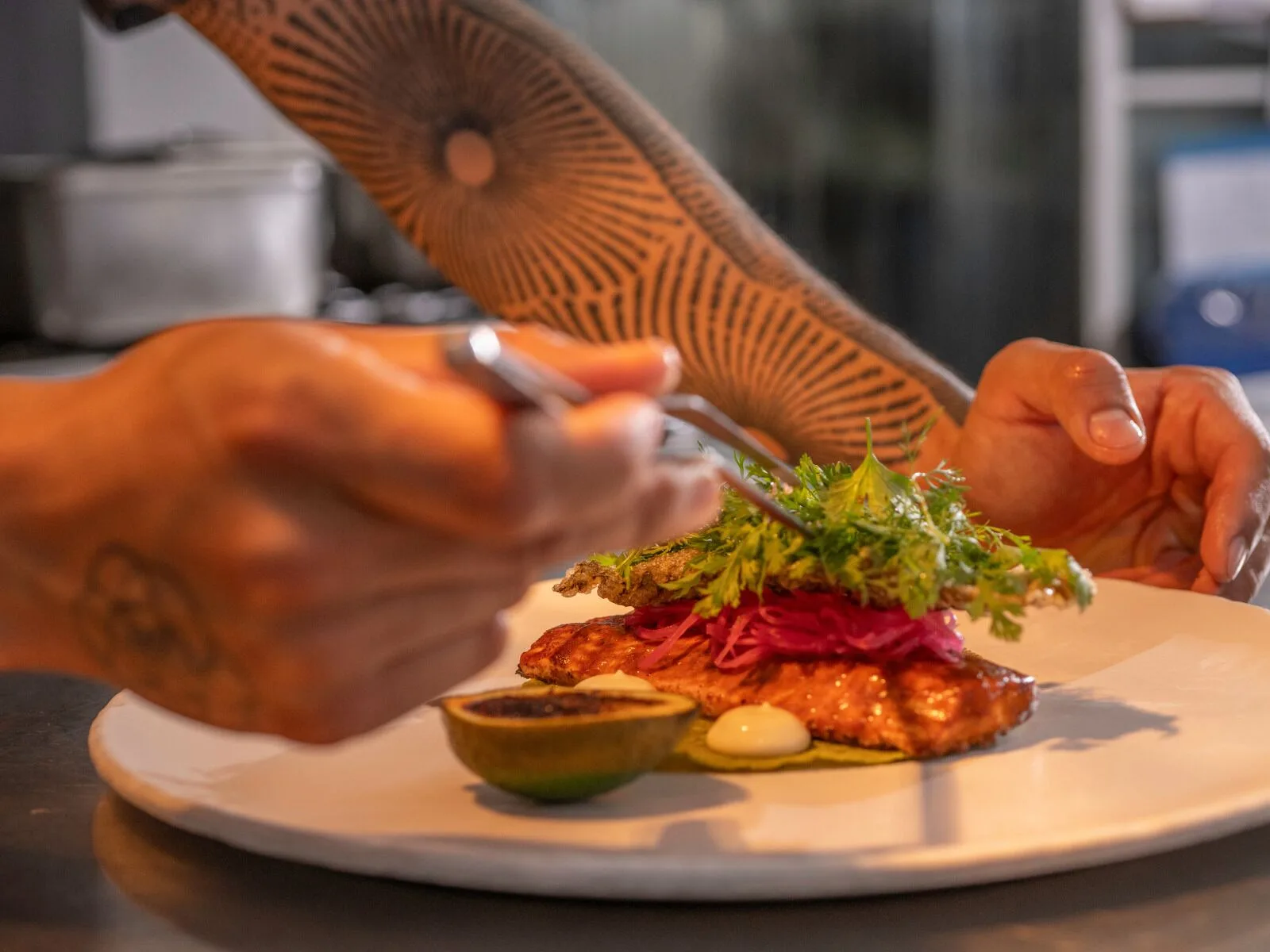 A chef plates a colorful seafood dish at Viceroy Riviera Maya.