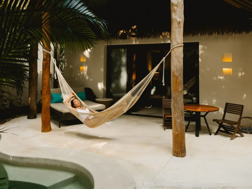 Nighttime villa terrace with hammock and plunge pool at Viceroy Riviera Maya.
