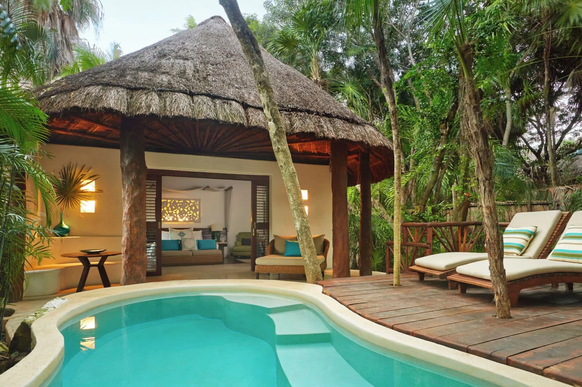 Royal Villa with Private Plunge Pool and Deck at Viceroy Riviera Maya featuring king bed, wooden deck, and private plunge pool in Playa del Carmen jungle.