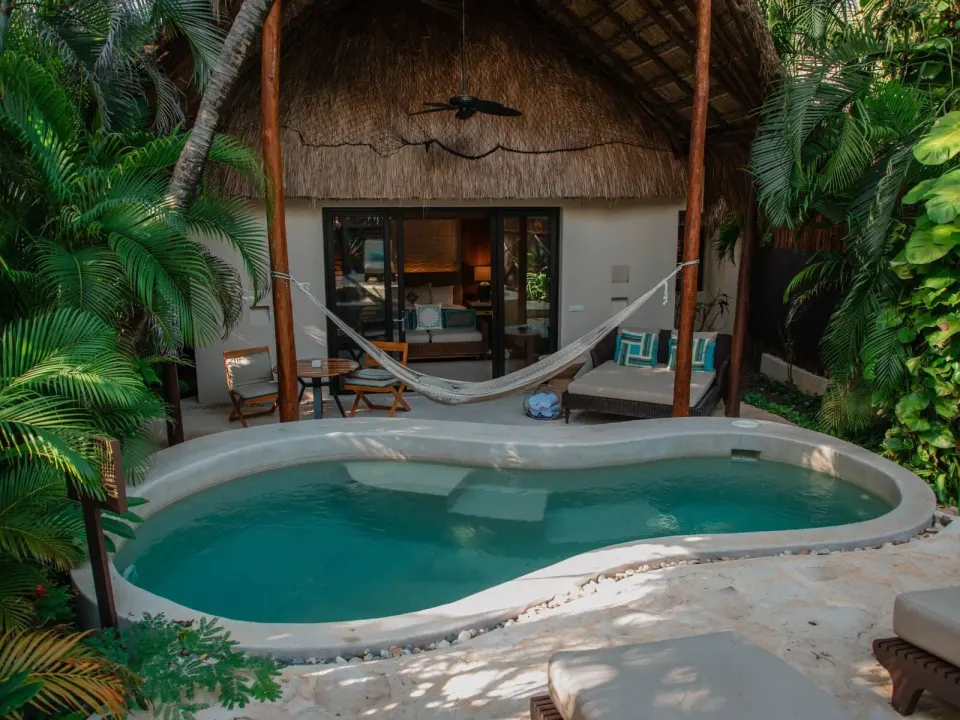 Royal Villa pool, hammock, and thatched terrace at Viceroy Riviera Maya.