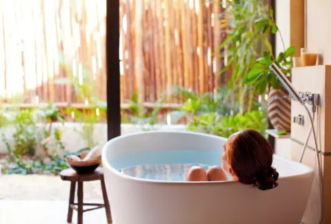 Signature Villa soaking tub beside garden doors at Viceroy Riviera Maya.