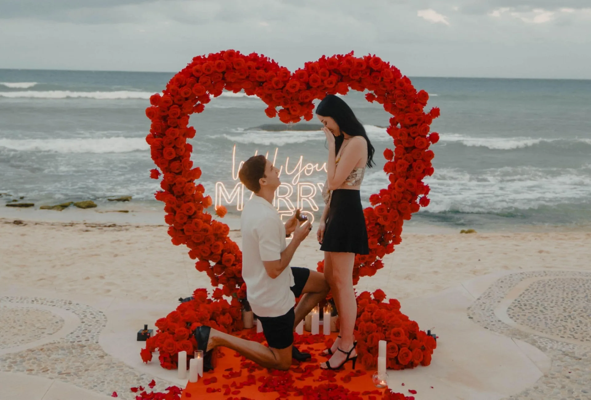 Beach proposal setup with red heart flowers at Viceroy Riviera Maya.