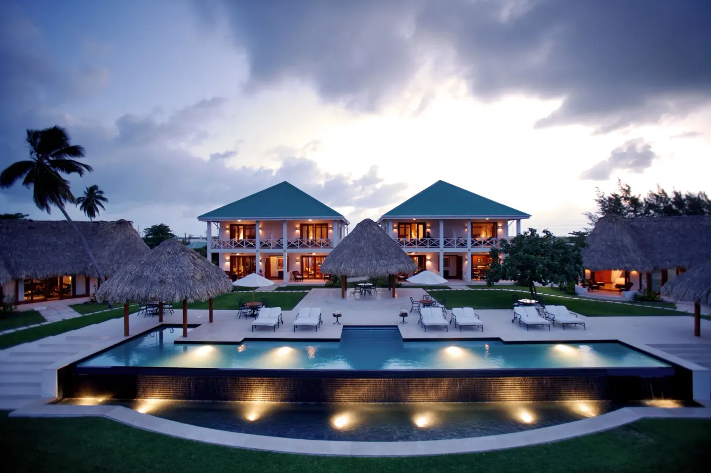 Evening pool and resort buildings at Victoria House Resort & Spa.