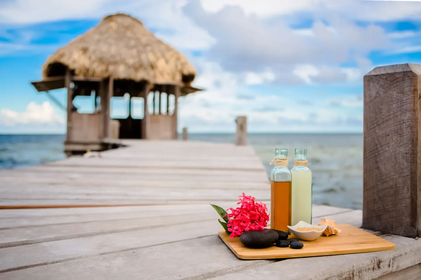Spa oils, stones, and flowers on a dock at Victoria House Resort & Spa.