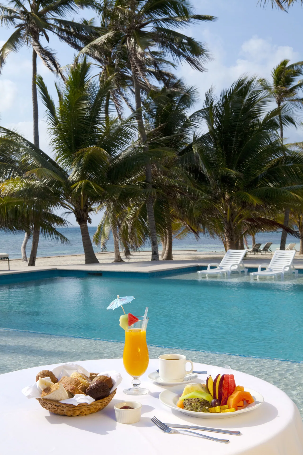Poolside breakfast with tropical fruit and juice at Victoria House Resort & Spa.