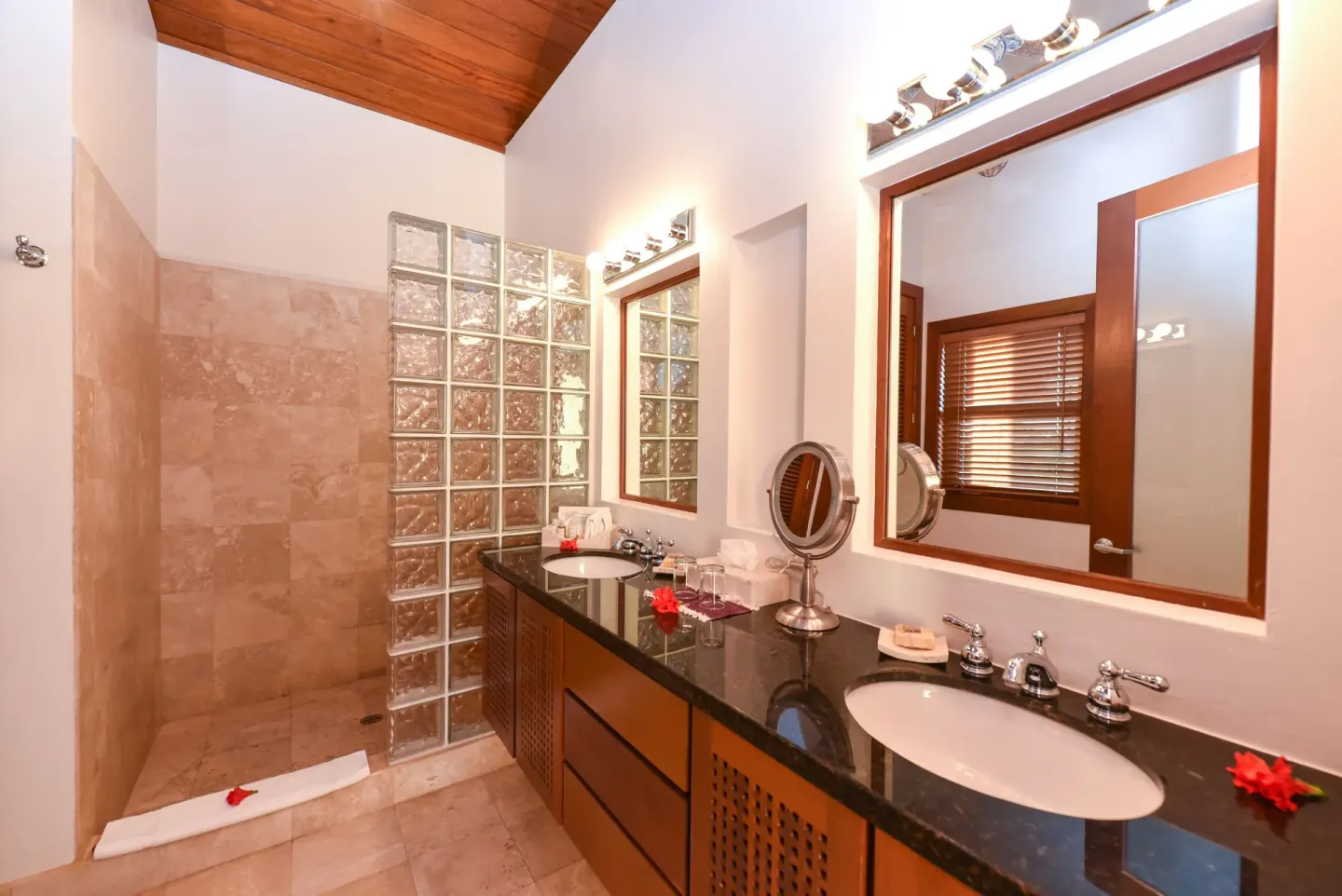 One Bedroom Infinity Suite bathroom vanity and shower at Victoria House Resort & Spa.