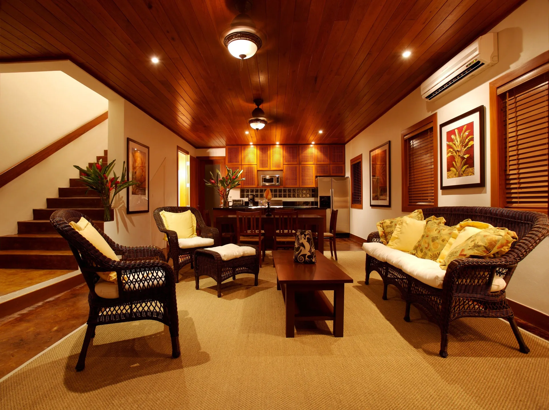 One Bedroom Infinity Suite lounge, stairs, and kitchen at Victoria House Resort & Spa.