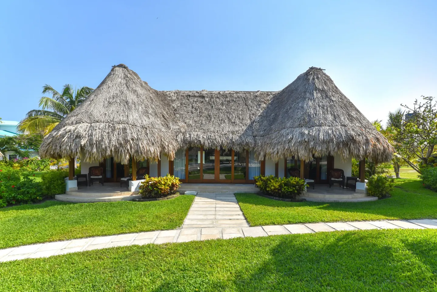 2 Bedroom Luxury Villa exterior with thatched roof at Victoria House Resort & Spa.