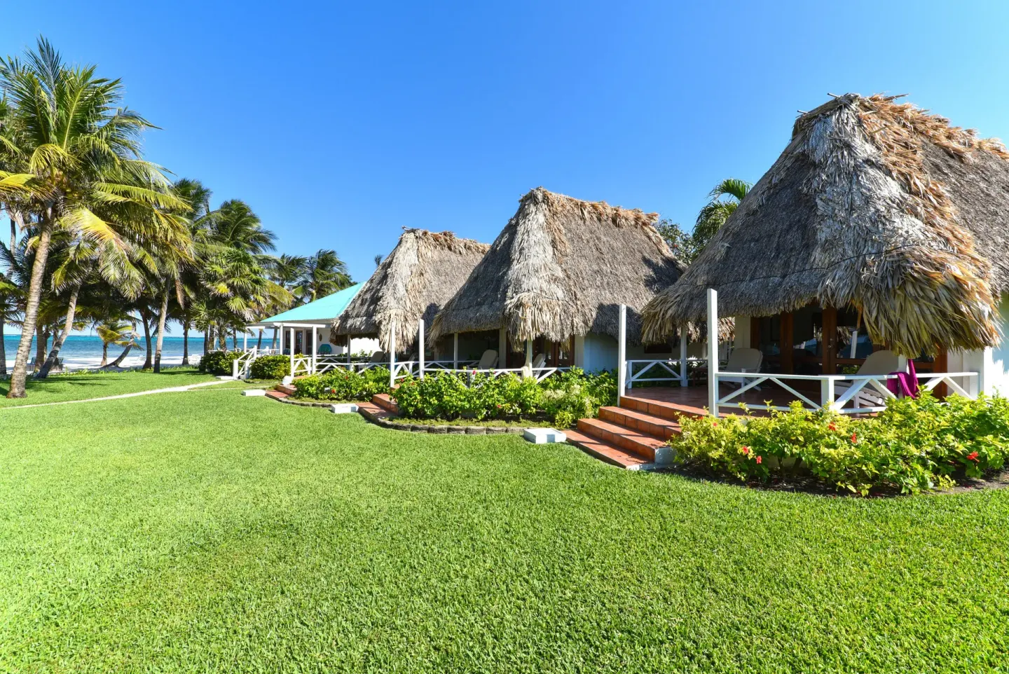 Casita exteriors on a beachfront lawn at Victoria House Resort & Spa.