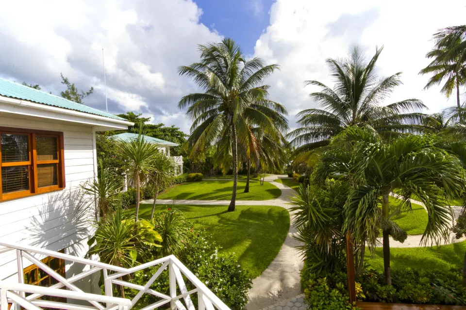 Stateroom exterior view with palms and garden paths at Victoria House Resort & Spa.