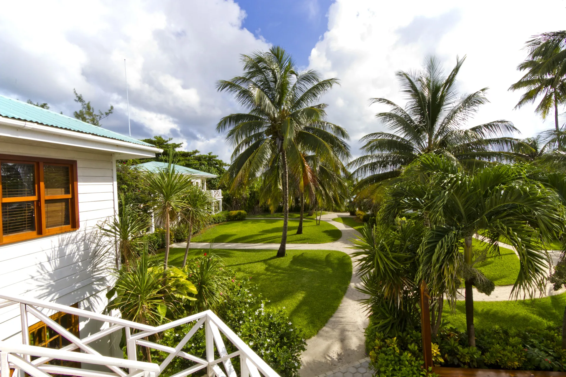 Stateroom exterior view with palms and garden paths at Victoria House Resort & Spa.