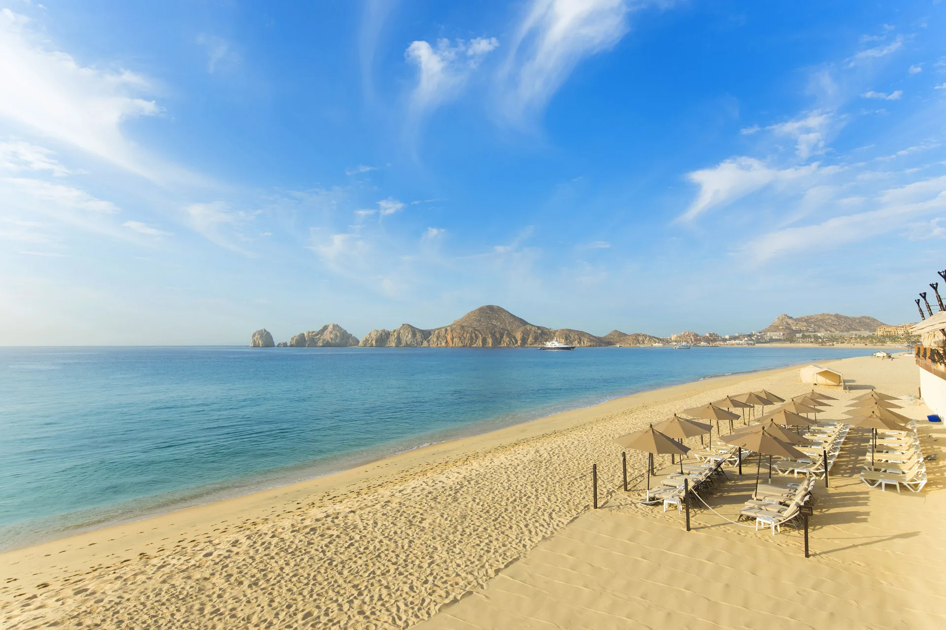 Beachfront with lounge chairs and ocean view at Villa del Arco Beach Resort & Spa Cabo San Lucas.