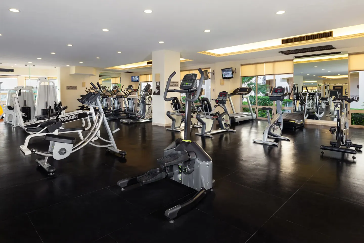 Wide fitness center with cardio and strength machines at Villa del Arco Beach Resort & Spa Cabo San Lucas.