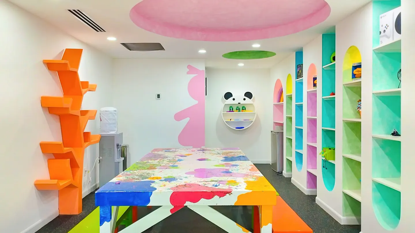 Colorful kids activity room at Villa del Arco Beach Resort & Spa Cabo San Lucas with a painted table and shelves.