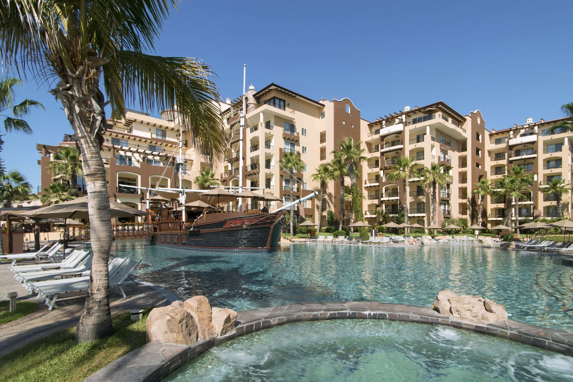 Pool and hot tub beside resort buildings at Villa del Arco Beach Resort & Spa Cabo San Lucas.