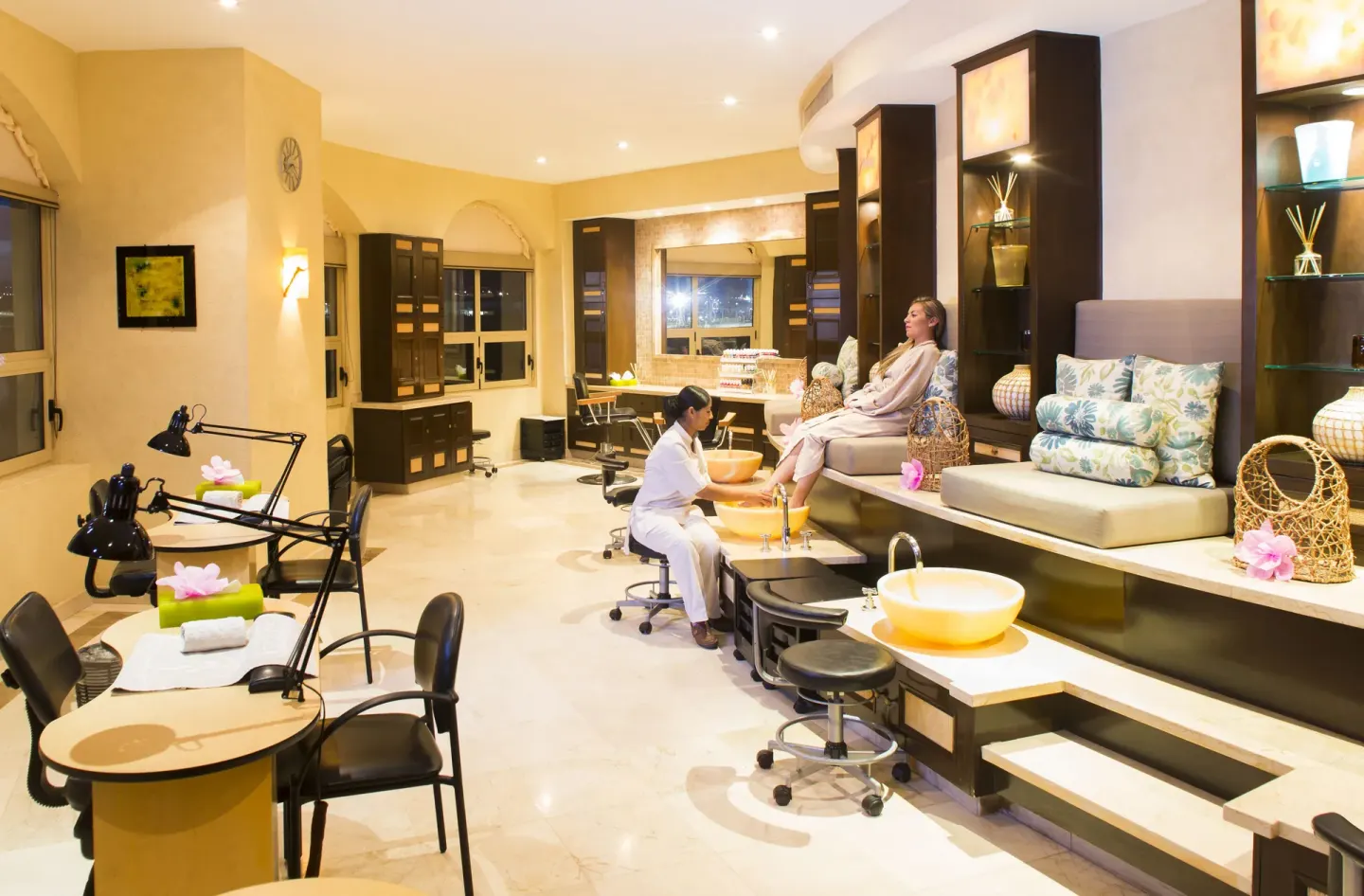 Pedicure lounge with a guest receiving foot care at Villa del Arco Beach Resort & Spa Cabo San Lucas.