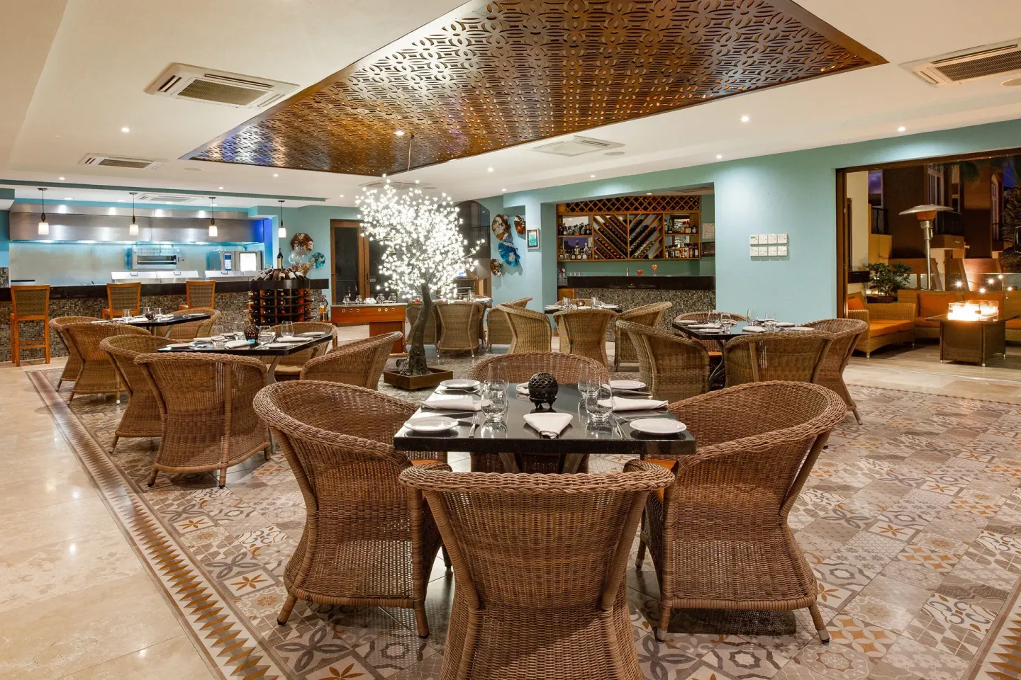 Indoor restaurant with wicker chairs at Villa del Arco Beach Resort & Spa Cabo San Lucas.
