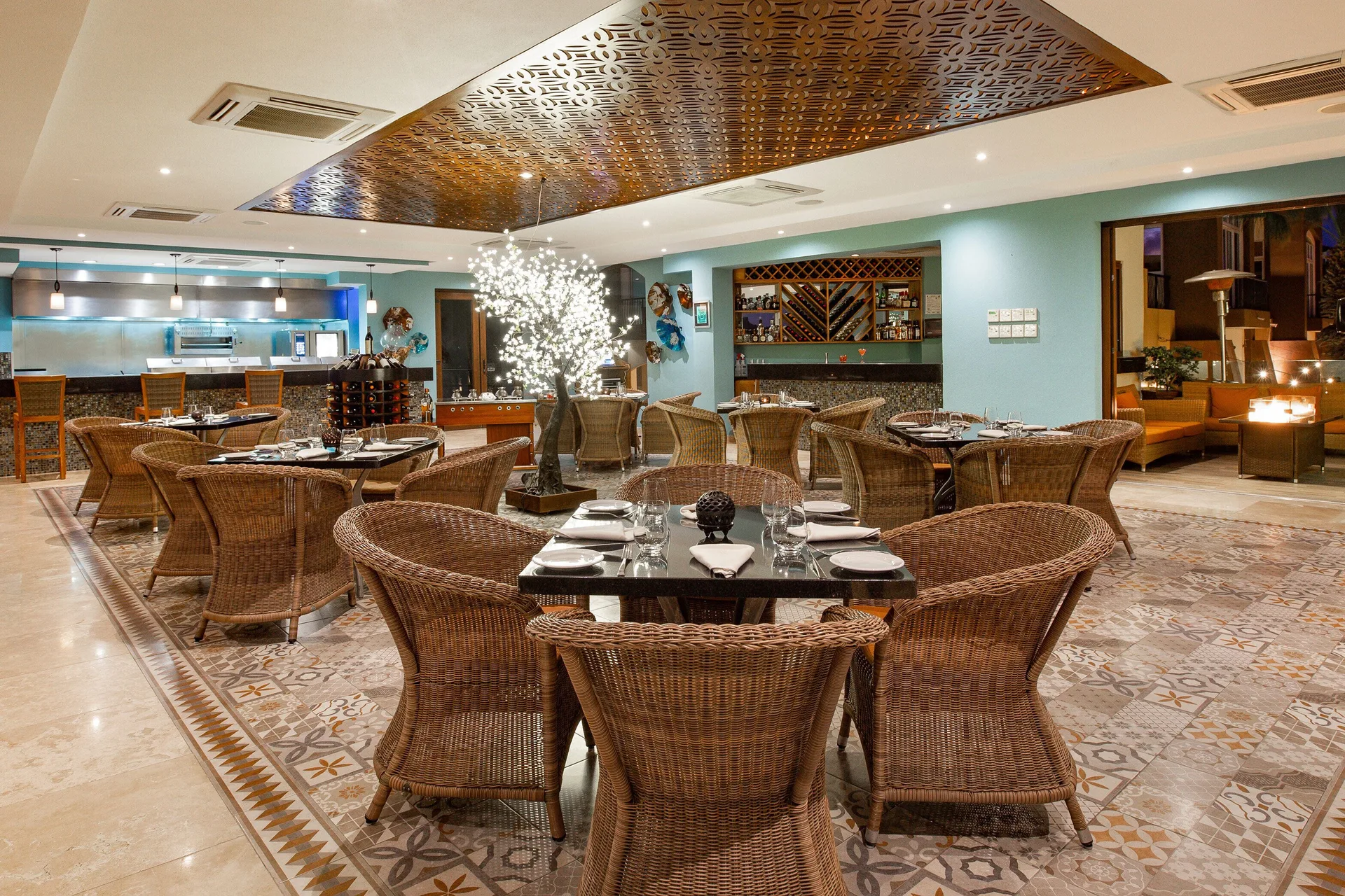 Indoor restaurant with wicker chairs at Villa del Arco Beach Resort & Spa Cabo San Lucas.