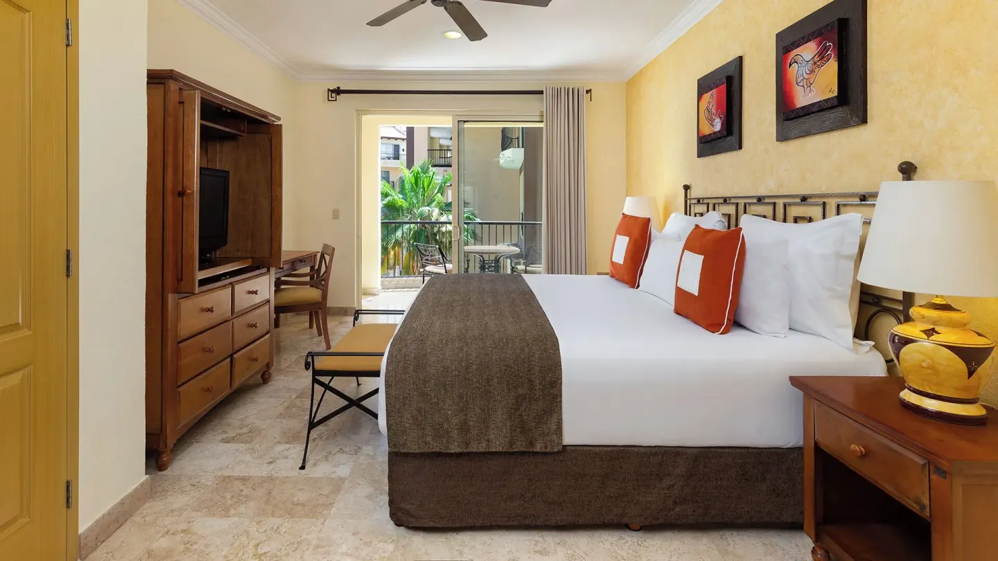 Deluxe Studio Garden View king bed and furnished balcony at Villa del Arco Beach Resort & Spa Cabo San Lucas.