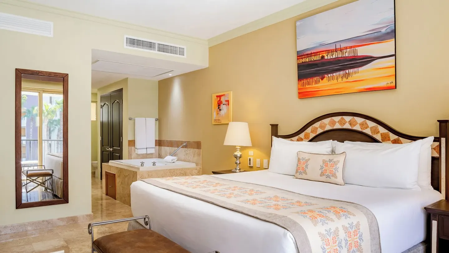 One Bedroom Suite Garden View king bed and in-room tub at Villa del Arco Beach Resort & Spa Cabo San Lucas.