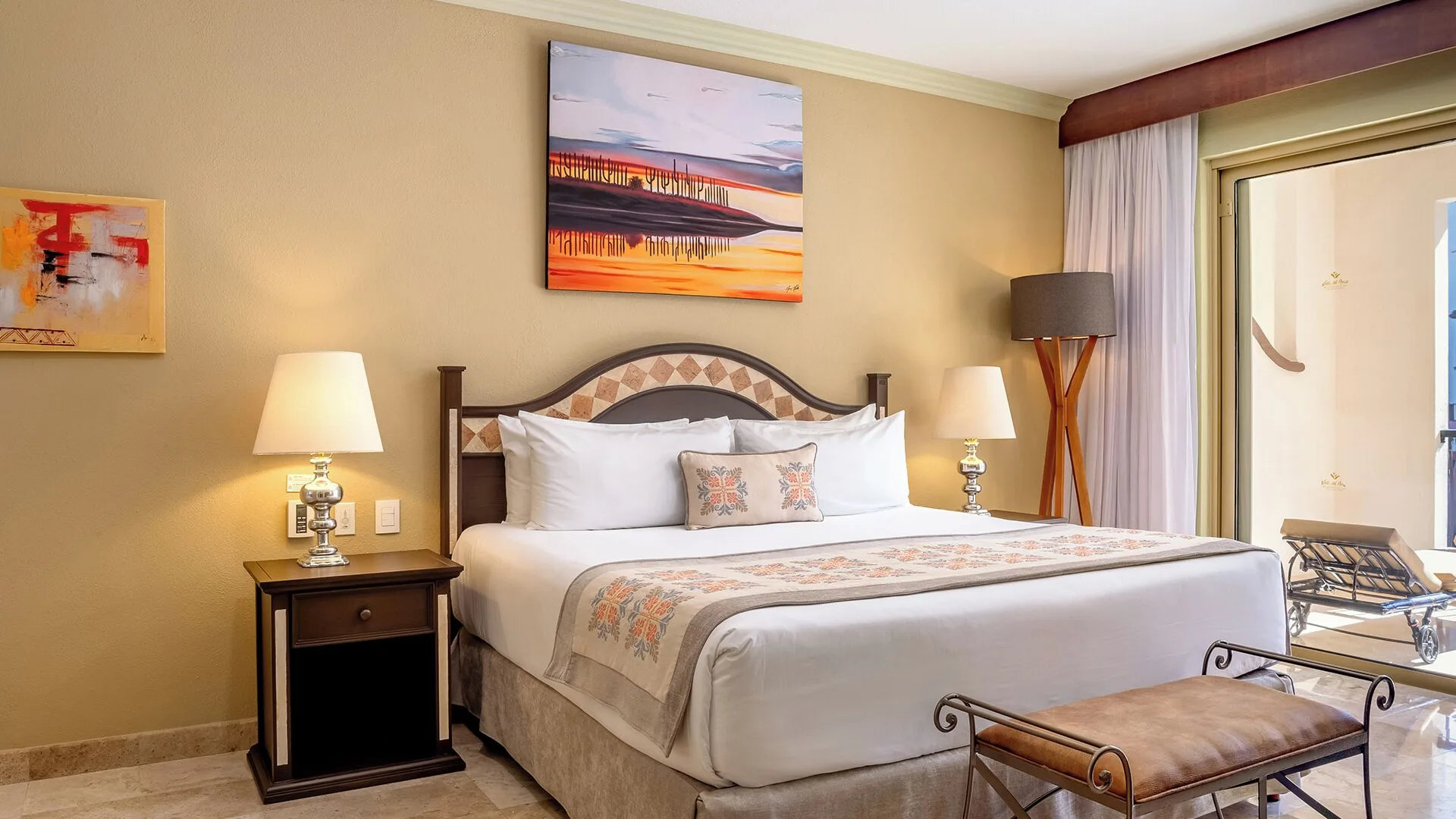 One Bedroom Suite Garden View king bed and balcony doors at Villa del Arco Beach Resort & Spa Cabo San Lucas.