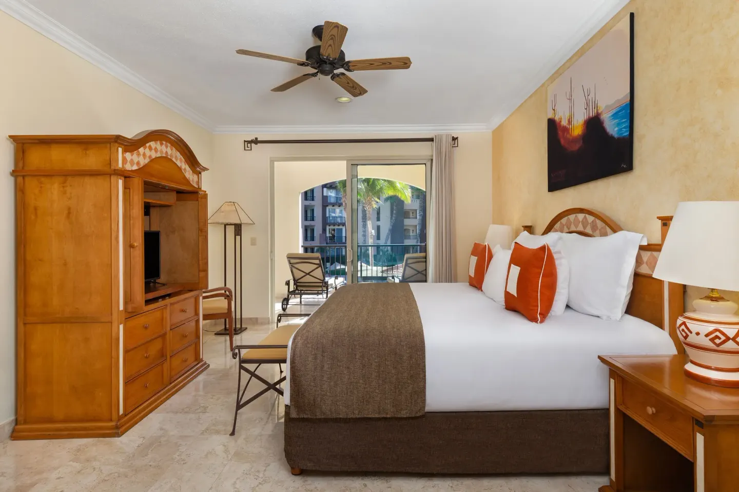 One Bedroom Suite Ocean View bedroom with king bed and balcony at Villa del Arco Beach Resort & Spa Cabo San Lucas.