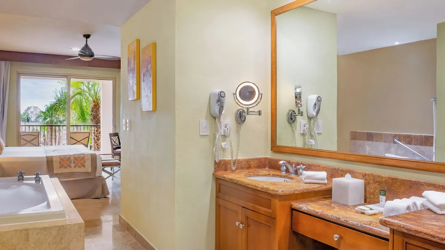Two Bedroom Suite bath vanity and bedroom balcony at Villa del Arco Beach Resort & Spa Cabo San Lucas.