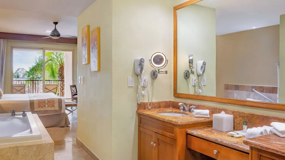 Two Bedroom Suite bath vanity and bedroom balcony at Villa del Arco Beach Resort & Spa Cabo San Lucas.