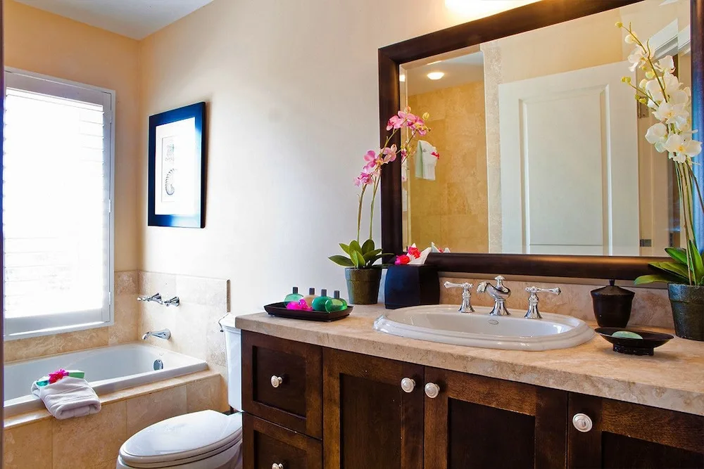 Bathroom vanity with tub, mirror and orchids at Villa del Mar.