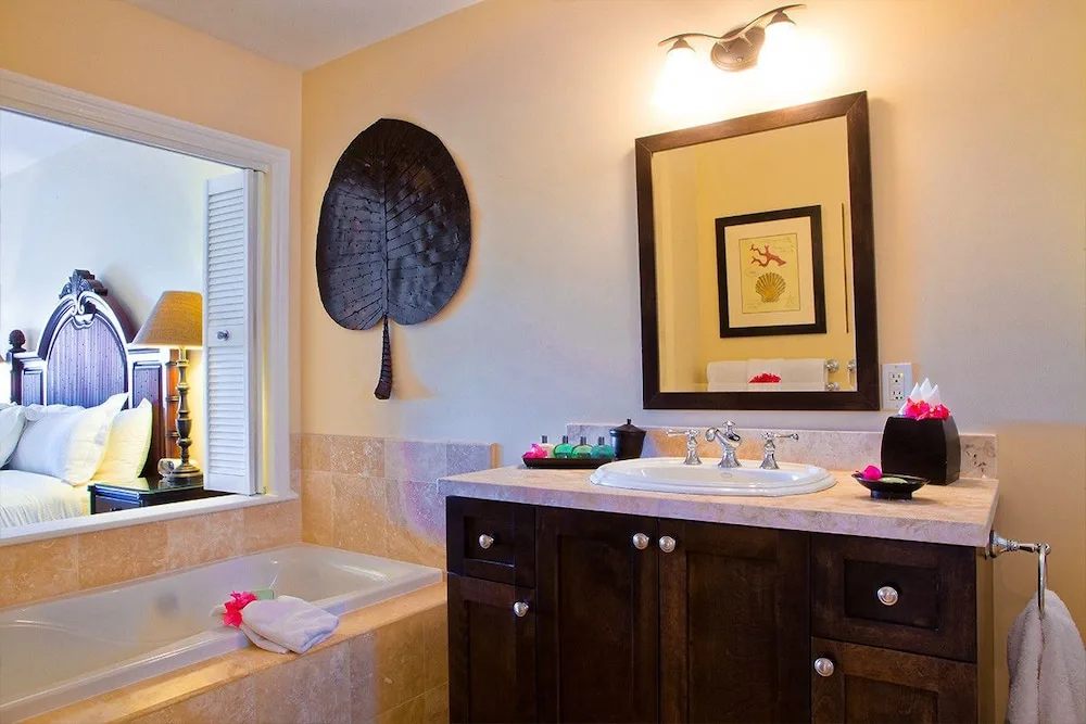 Bathroom vanity and soaking tub beside a bedroom window at Villa del Mar.