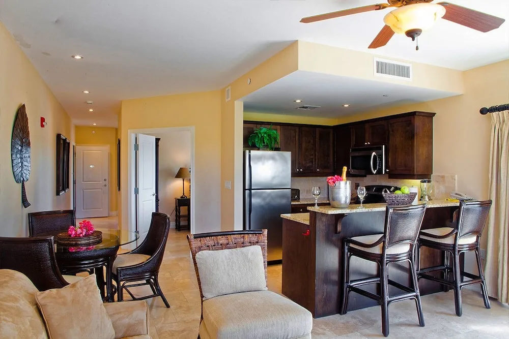 Dining area and kitchen with breakfast bar and hallway at Villa del Mar.