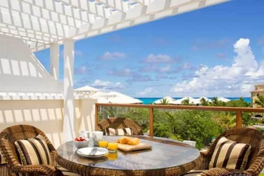 Covered terrace with wicker chairs at Villa del Mar.