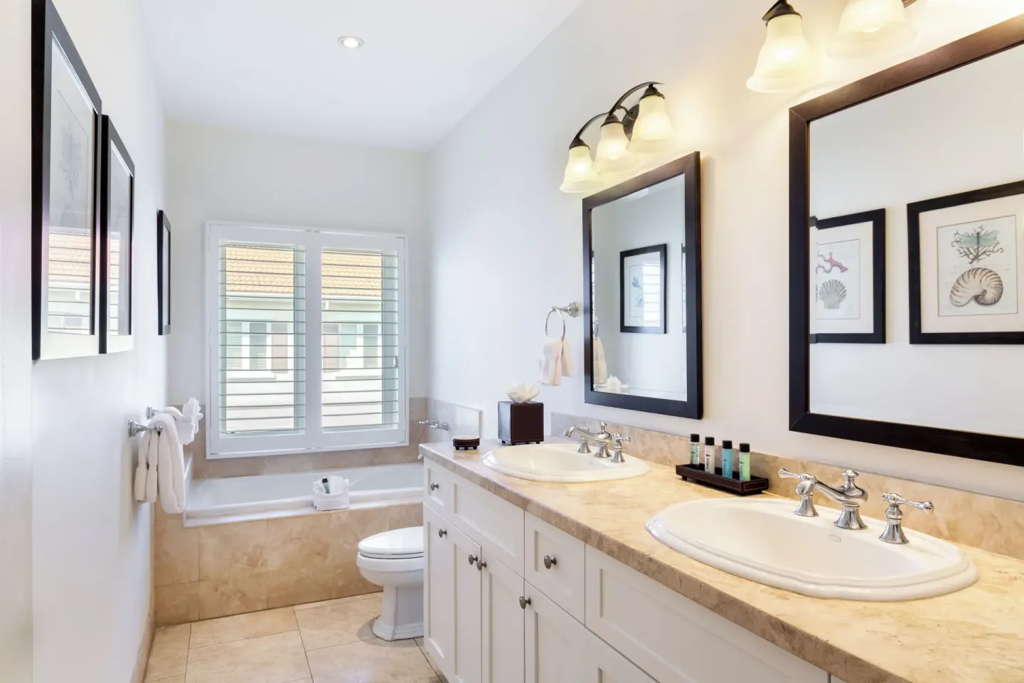 Luxury Penthouse bathroom with double vanity and shuttered window at Villa del Mar.
