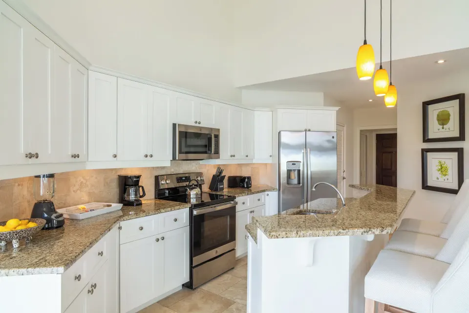 Luxury Penthouse kitchen with granite counters and bar seating at Villa del Mar.