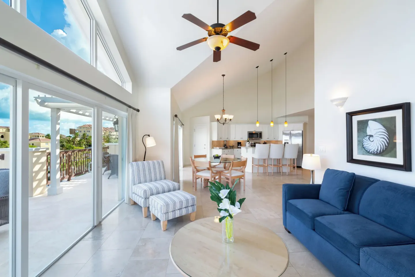 Luxury Penthouse living room with blue sofa and balcony doors at Villa del Mar.