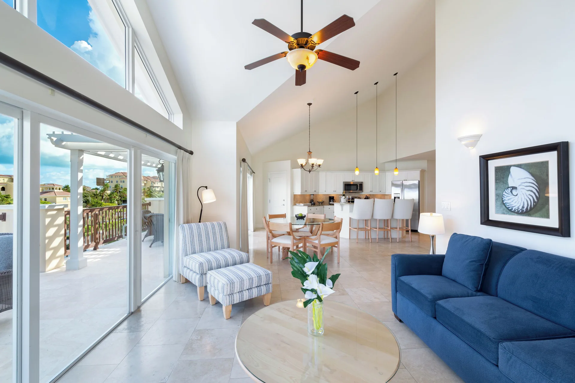 Luxury Penthouse living room with blue sofa and balcony doors at Villa del Mar.