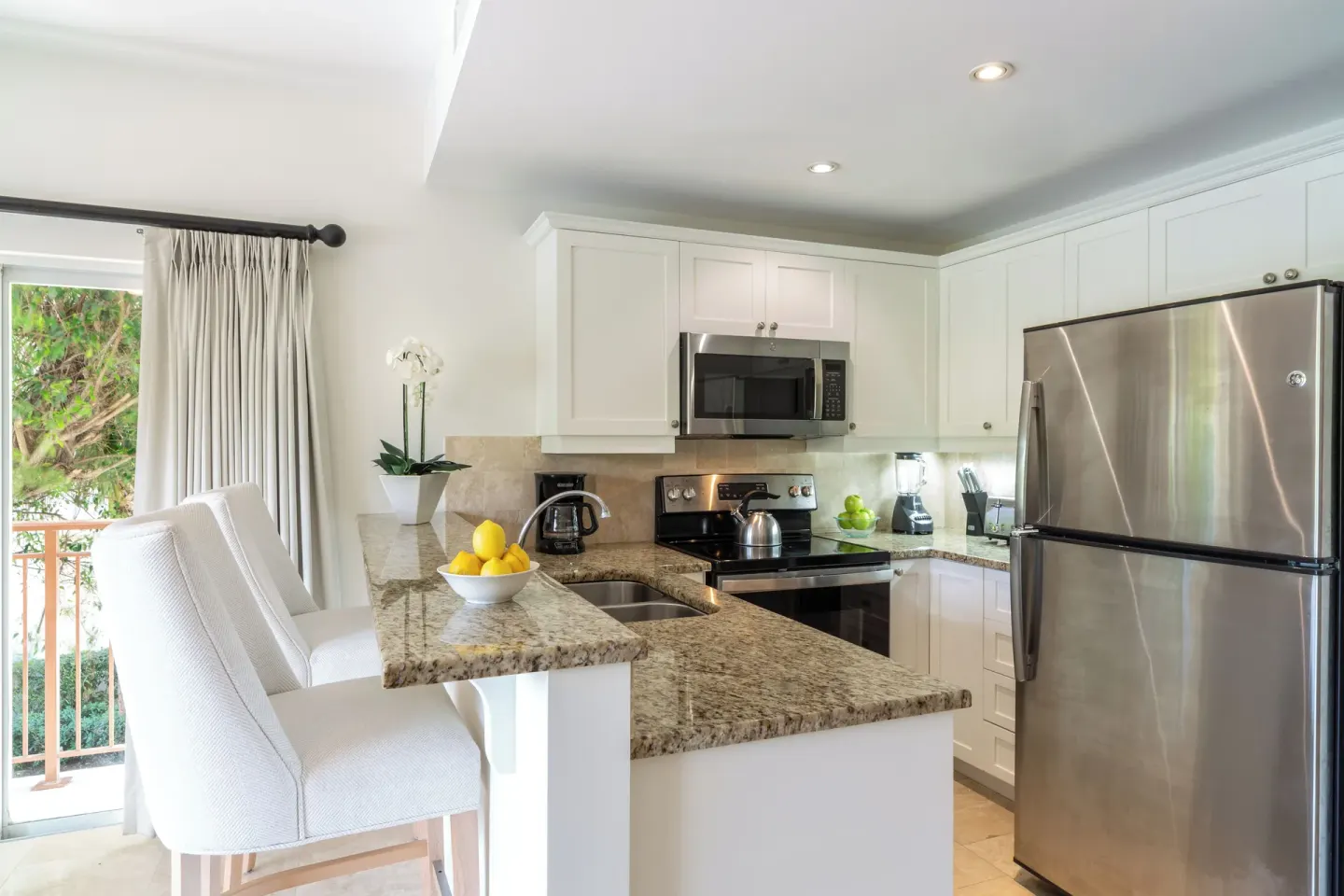 Luxury Suite kitchen with breakfast bar and stainless appliances at Villa del Mar.