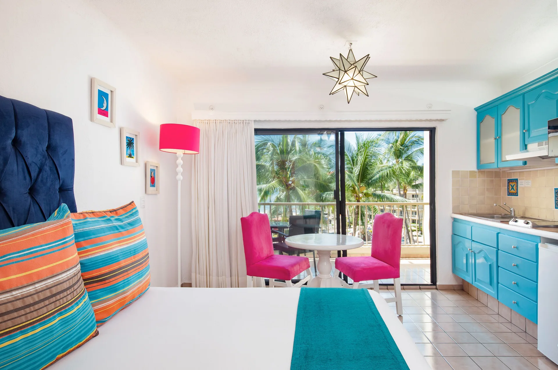 Junior Suite bed, kitchenette, and balcony at Villa del Palmar Beach Resort and Spa, Puerto Vallarta.