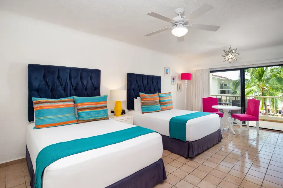Junior Suite with two beds and balcony at Villa del Palmar Beach Resort and Spa, Puerto Vallarta.
