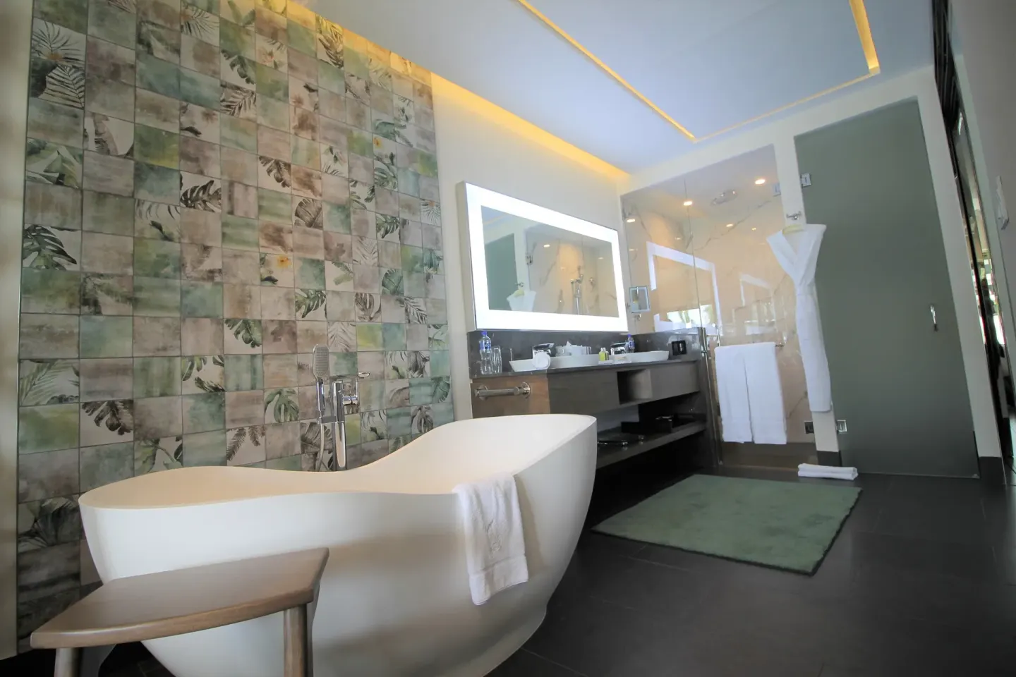 Bathroom with freestanding tub and leaf-pattern tile at Villa del Palmar Cancun Beach Resort & Spa.
